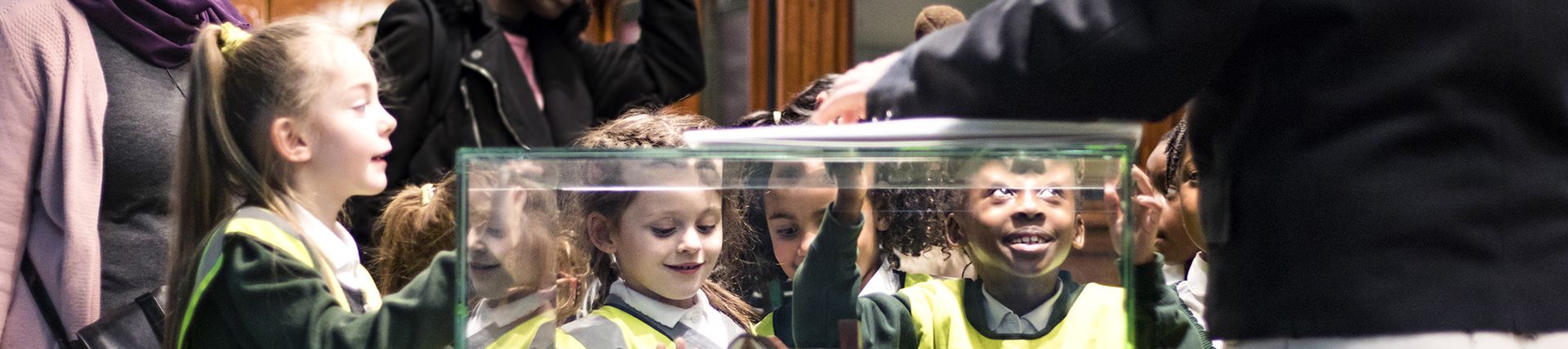 A group of school children looking at an exhibit in the Museum