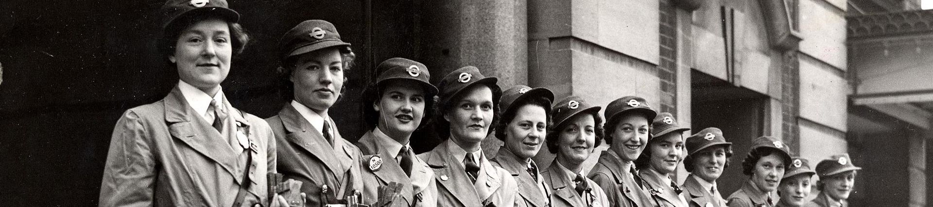 Black and white photograph from 1942 of 12 women lined up in their bus and trolleybus conductors uniform