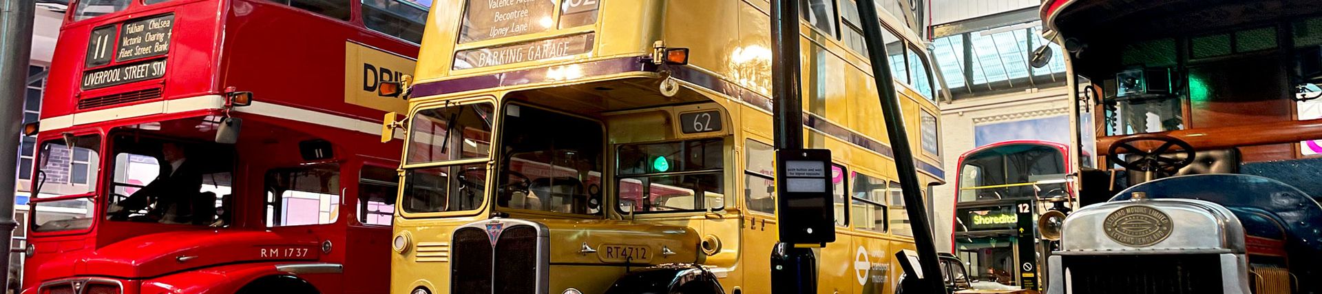 A red, gold and old fashioned bus inside the Museum galleries